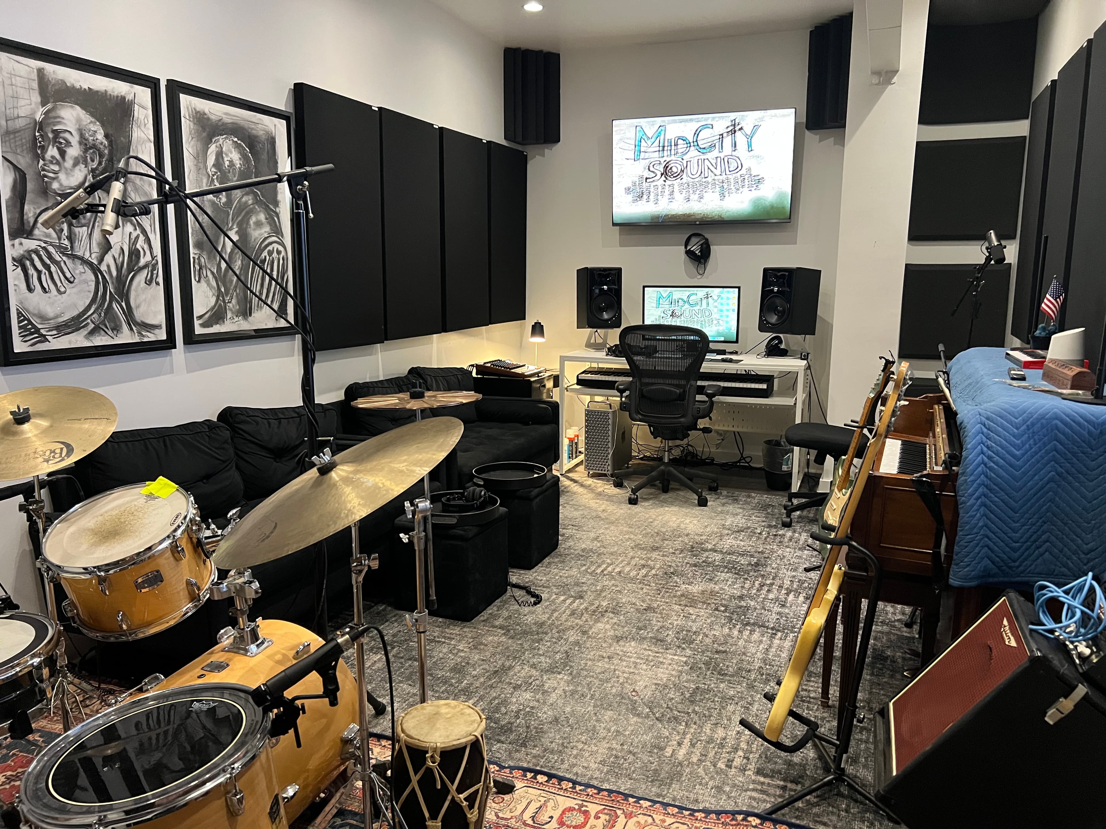Studio B live room with drum kit and upright piano